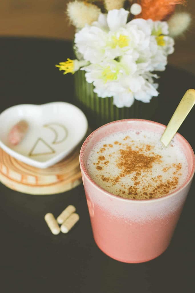 Shatavari latte in a glass with shatavari capsules displayed — how to take shatavari for women as a nourishing daily elixir.