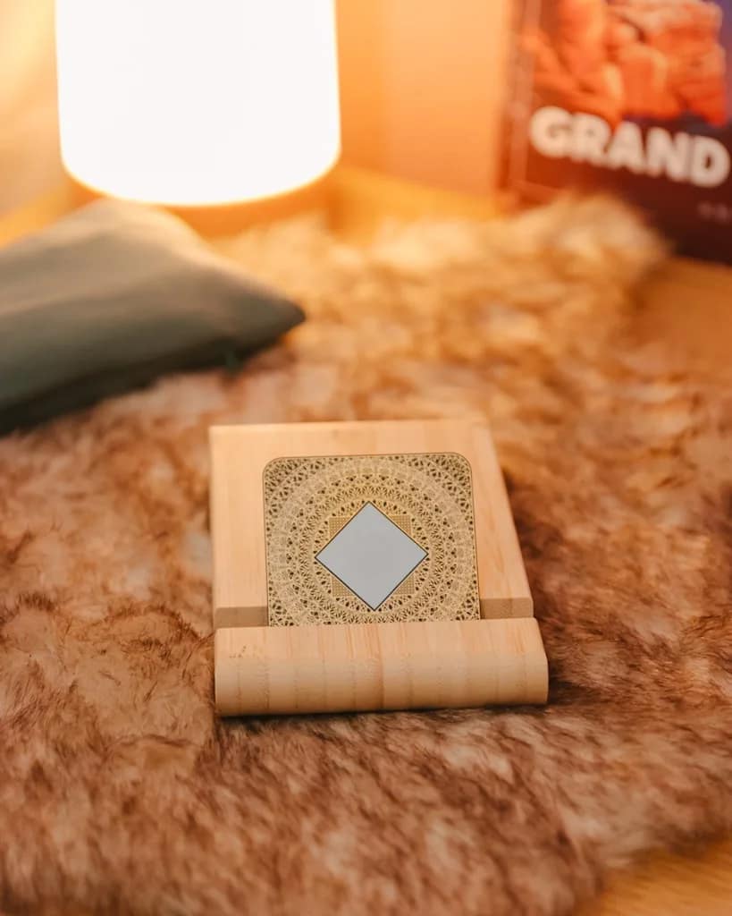 Aires Tech Lifetune Zone on wooden nightstand — part of a real bedroom EMF setup for post-viral sleep recovery.