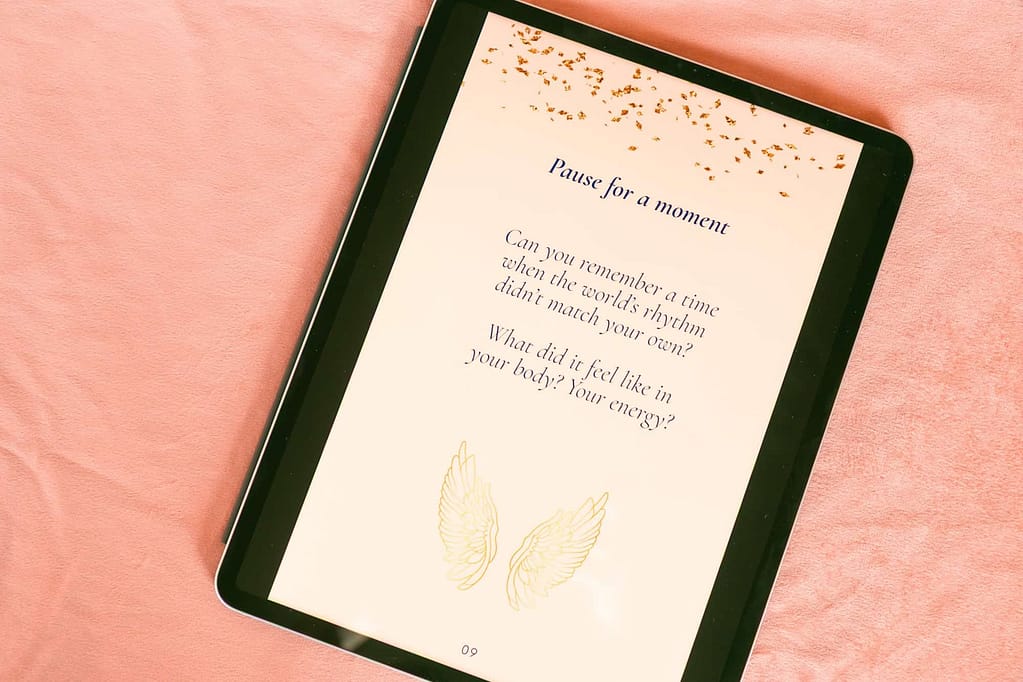 Close-up of The Indigo Healing Guide cover on an iPad screen, surrounded by natural textures and calming earth tones — a nervous system healing guide for quantum sensitives, reflecting the essence of slow, embodied, and intuitive healing.