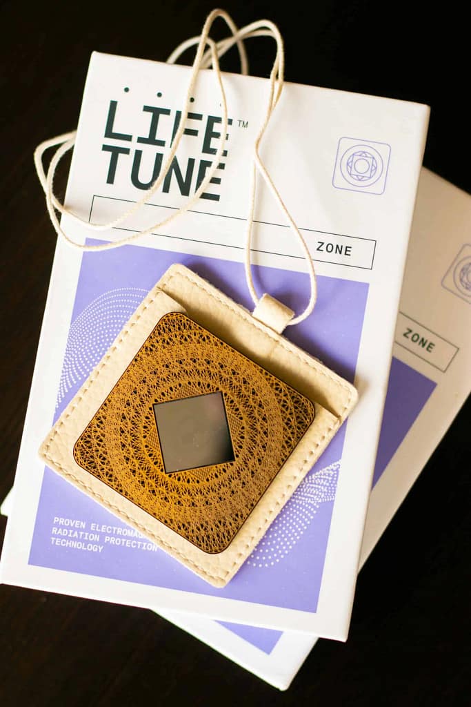 Aires Zone EMF device with leather travel pouch for portable frequency protection.